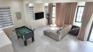 a living room with a foosball table and a couch at Solara Coast Villa in Tiến Thành