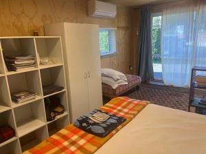 a bedroom with a bed and a book shelf at The Windsor Suite in New Plymouth +1 photo