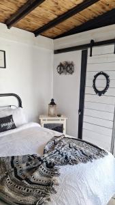 a bedroom with a bed and a door with a wreath at Kokomo Farms in Live Oak