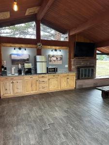 a large room with a entertainment center with a flat screen tv at Columbine Inn in Estes Park