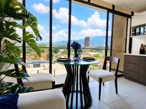 a table and chairs in a room with a large window at Estudio 905 in San Salvador