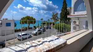a balcony with a view of a parking lot at Beachfront Bliss in Pissouri