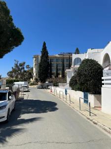 a street with cars parked on the side of a building at Beachfront Bliss in Pissouri +4 photos