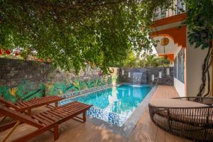 a swimming pool with a bench and a table at Nova Vista Villa Hoi An in An Bàn (2) +8 photos