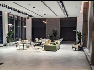 a lobby with a green couch and tables and chairs at Gaslight in Cambridge