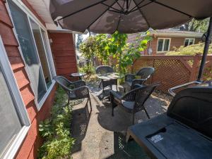 a patio with chairs and a table and an umbrella at Home rental S7 in Saint Maurice