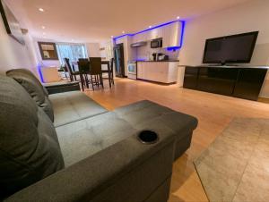 a large living room with a couch and a kitchen at Home rental S7 in Saint Maurice +6 photos