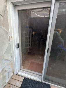 a sliding glass door of a door with a window at Home rental S7 in Saint Maurice