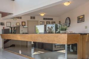 a lobby with a counter with plants on it at Rodeway Inn Fallsview in Niagara Falls