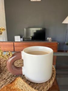 a cup of coffee sitting on top of a table at La Luna in Villa Serrana