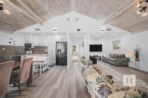 a living room and kitchen with a couch and a table at Sunset Escape in Summerland Point