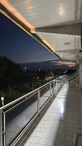 a balcony of a building with a view of the night at Visk Palace Hotel e Restaurante in Foz do Iguaçu