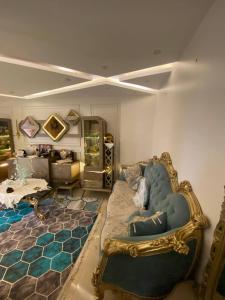a living room with a blue couch in a room at Bianki Home in Alexandria