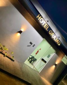 a window of a store with a sign on it at Hotel Grajaú in Arcos +1 photo