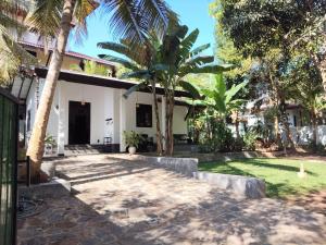 a courtyard of a house with palm trees at Galhena Villa in Tangalle