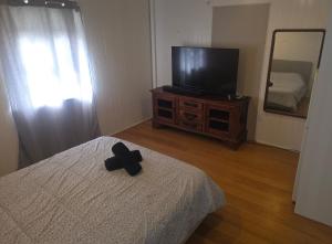 a cross sitting on top of a bed in a bedroom at Buchan Street, Accommodation in East Trinity