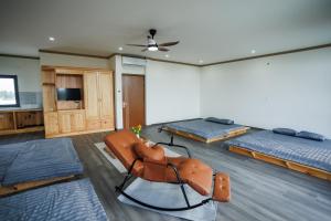 a room with two beds and a chair in it at Khách Sạn Vân Nguyên in Buôn Ea Yông +27 photos