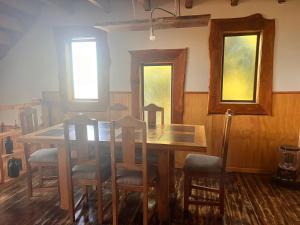 a dining room with a wooden table and chairs at Colibrí lodge in Recinto +9 photos