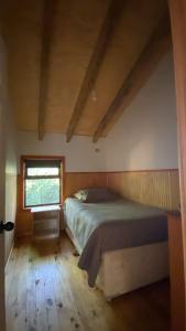 a bedroom with a bed and a window at Colibrí lodge in Recinto