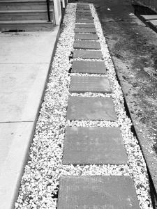 a walkway with rocks on the side of a sidewalk at Maple Nest in Regina