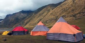 three tents in a field with mountains in the background at Selena Camping in Tayapampa +41 photos