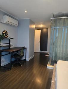 a living room with a table and a chair at Astoria Plaza Residential in Manila