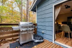 a stove sitting on a deck next to a house at Three Trees Retreat in Ellijay