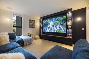 a living room with a large flat screen tv at Vanda Heights in Queenstown