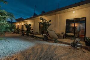 a building with plants on the side of it at night at Casa Shalom Green in Bacalar