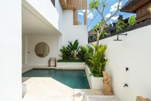 a swimming pool in the middle of a house at Villa Ombak - 1BR Private Luxury Villa 150m from Seseh Beach in Canggu