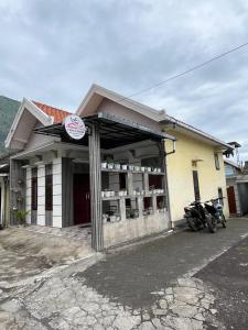 a building with a motorcycle parked in front of it at Widodaren Homestay in Probolinggo +6 photos