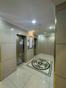 a hallway of a building with a room with a clock on the floor at Miga's guest house & tour in Ulaanbaatar