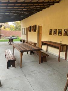 a group of picnic tables and benches on a patio at Recanto da Caluninha in Esmeraldas