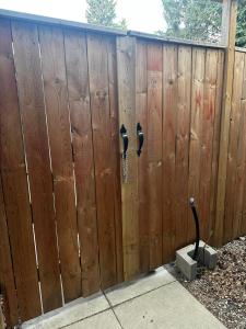 a wooden fence with two parking meters on it at 1500 Sqft Entire Basement Cozy Private Suite in Saskatoon