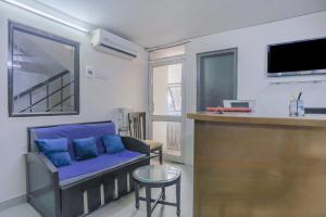 a living room with a blue couch and a bar at Collection O Green Park Residency 3 in New Delhi