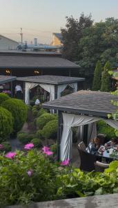 a group of people sitting at a table in a garden at Центральна Садиба in Kryzhanivka