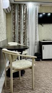 a dining room with a table and a table and chairs at Центральна Садиба in Kryzhanivka