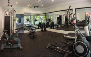 a gym with several exercise equipment and a mirror at The Local Time Village in Siem Reap