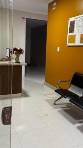 an office with a chair and a yellow wall at Villas Hotel in Barreiras