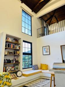 a living room with a couch and a window at Finca San Mateo - Private Luxury Coffee Estate in Antigua Guatemala in Antigua Guatemala