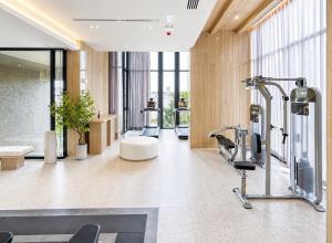 a gym with exercise equipment in a building at Luxury Riverside Condo with riverside pool in Bangkok