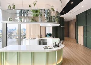 a room with a white counter with plants on it at Luxury Riverside Condo with riverside pool in Bangkok