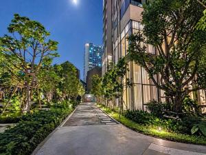 a street in a city with a car driving down the street at Luxury Riverside Condo with riverside pool in Bangkok
