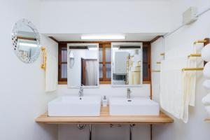 a bathroom with two sinks and mirrors at Hagizen in Hagi +54 photos