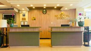 a lobby of a hotel with two counters at Microtel Inn & Suites by Wyndham San Fernando in San Fernando