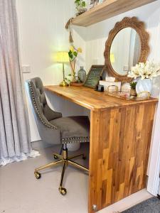 a wooden desk with a mirror and a chair at Edington on Mary - The Dairy in Gympie