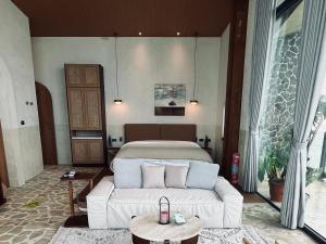 a bedroom with a white bed in a room at Lemeraude BnB in Hengchun South Gate