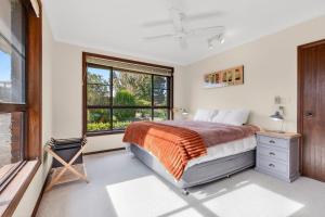 a bedroom with a bed and a window at Brodie Getaway in Coffs Harbour