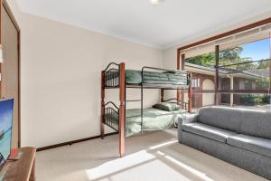 a room with a bunk bed and a couch at Brodie Getaway in Coffs Harbour +9 photos