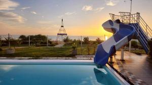 a slide in front of a swimming pool at Nara Paradise Beach in Narathiwat